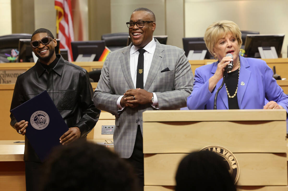 Usher Raymond IV, left, smiles after receiving a proclamation from Las Vegas City Councilman Ce ...