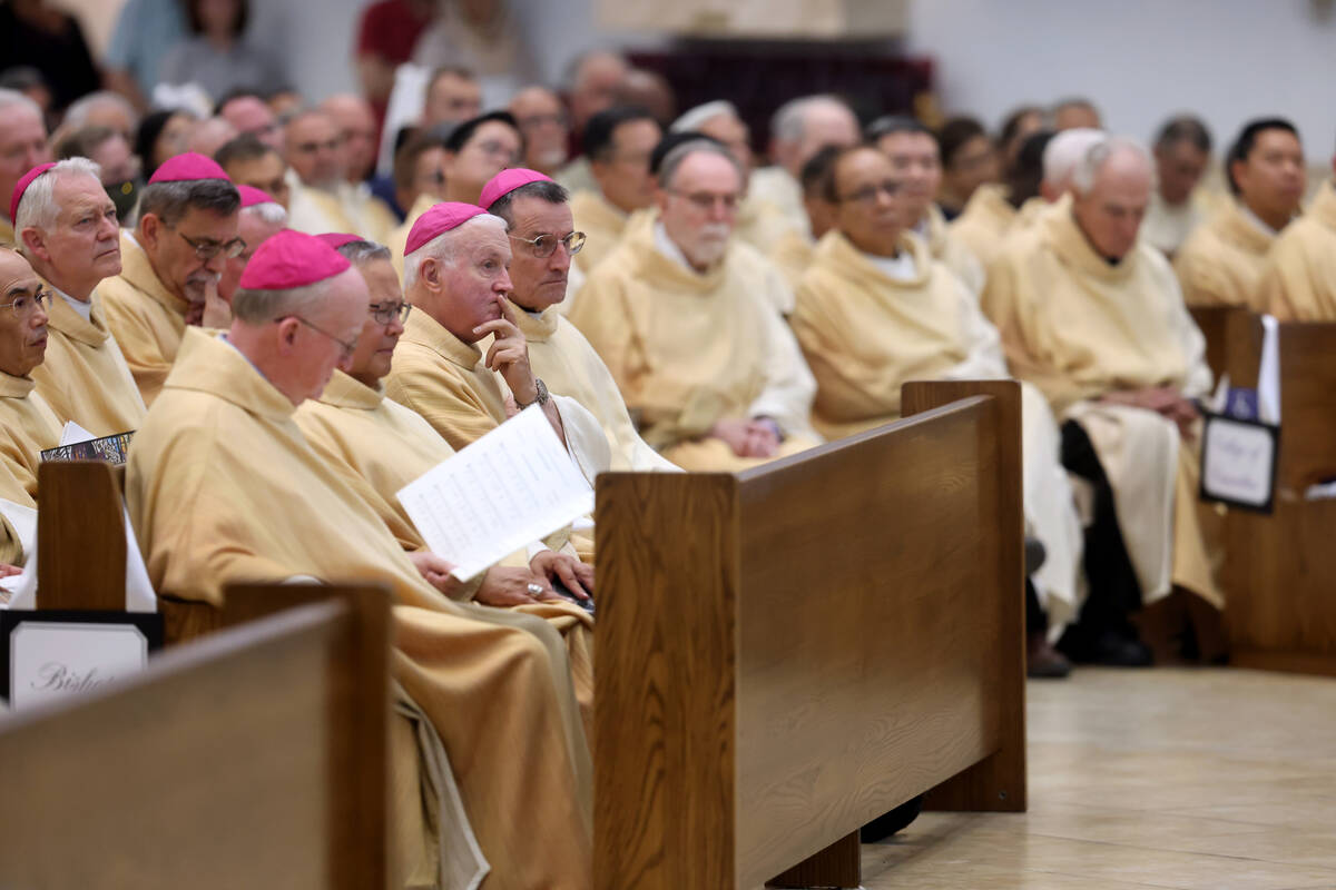 Members of the clergy listen during the imposition of the Pallium Mass at the Shrine of the Mos ...