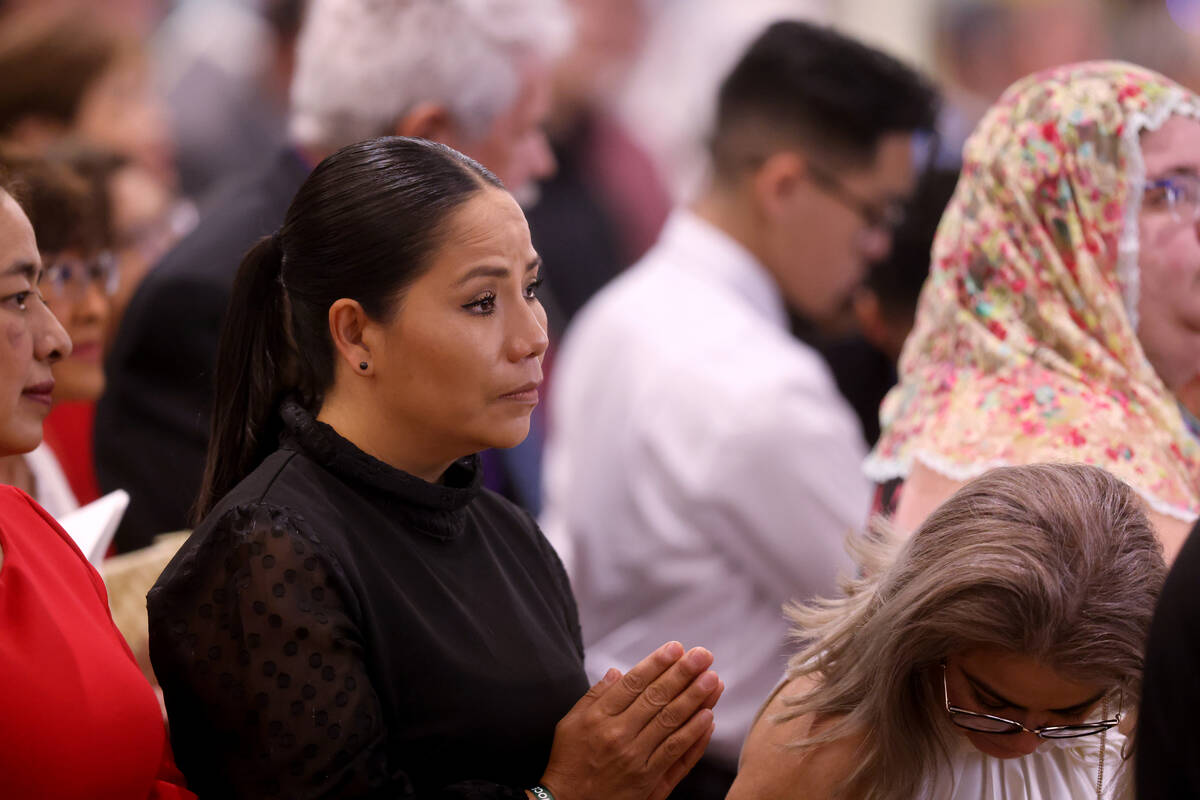 Avelina Murillo of Las Vegas worships during the imposition of the Pallium Mass at the Shrine o ...
