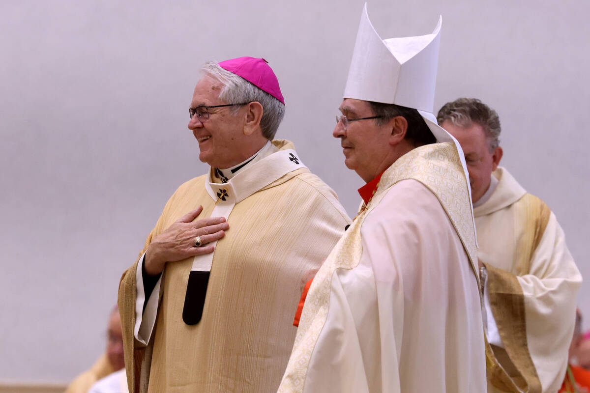Archbishop George Leo Thomas, left, receives the Pallium from Apostolic Nuncio to the United St ...