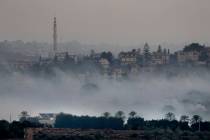 Israeli artillery shelling smoke covers Dahaira, a Lebanese border village with Israel, south L ...