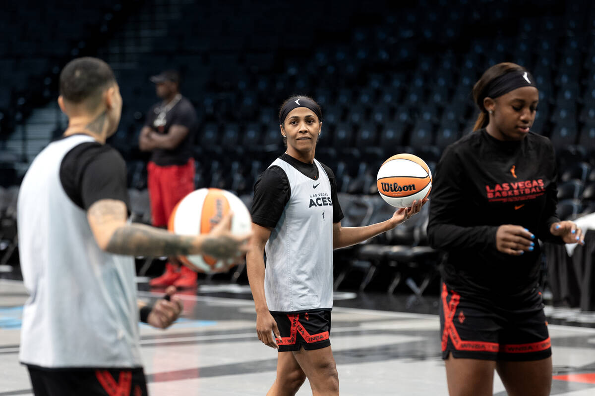 Las Vegas Aces guard Sydney Colson warms up for practice flanked by guards Kierstan Bell, left, ...