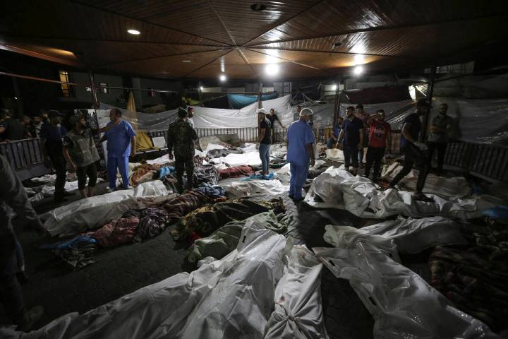 Bodies of Palestinians killed by an airstrike that hit the Ahli Arab hospital are seen gathered ...