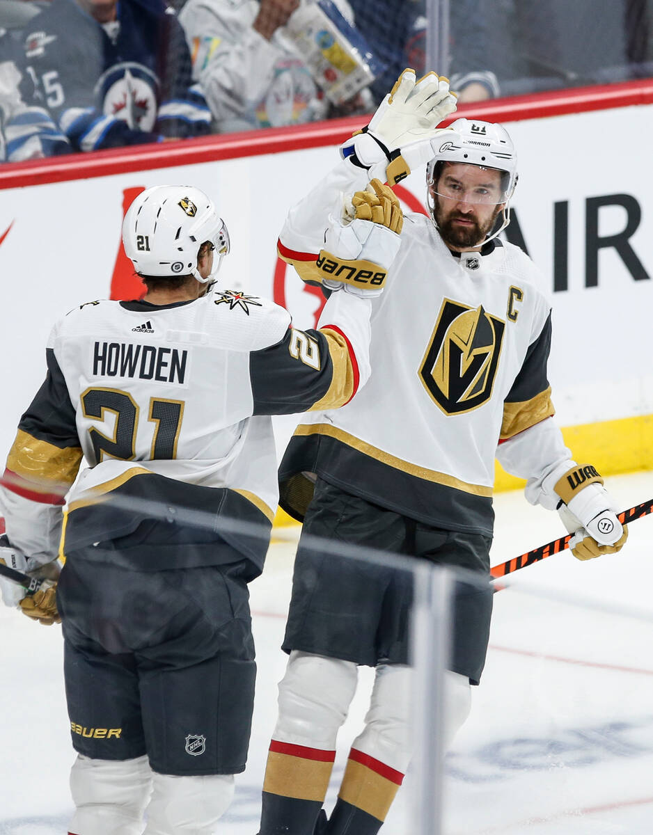 Vegas Golden Knights' Brett Howden (21) and Mark Stone (61) celebrate after Howden's goal again ...