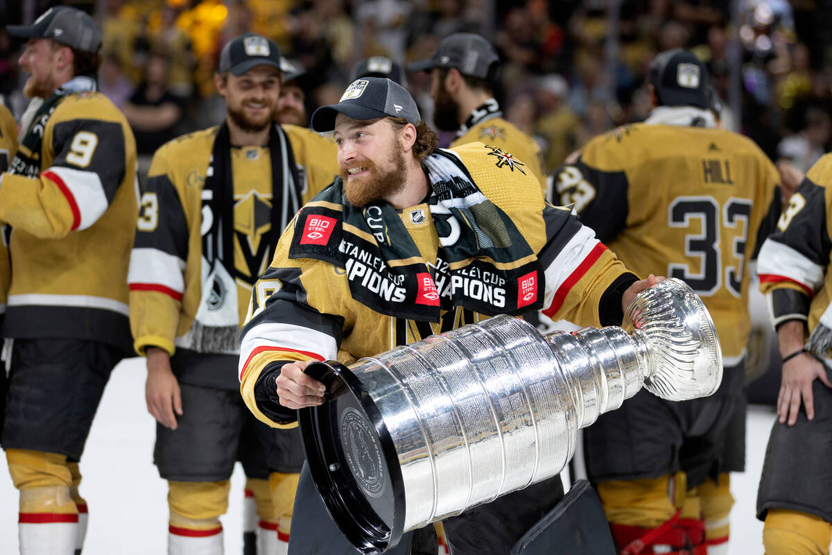 Golden Knights goaltender Laurent Brossoit (39) celebrates with the Stanley Cup after winning t ...