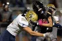 Foothill middle linebacker Hayden Findley (26) tackles Faith Lutheran running back Mason Aday ( ...