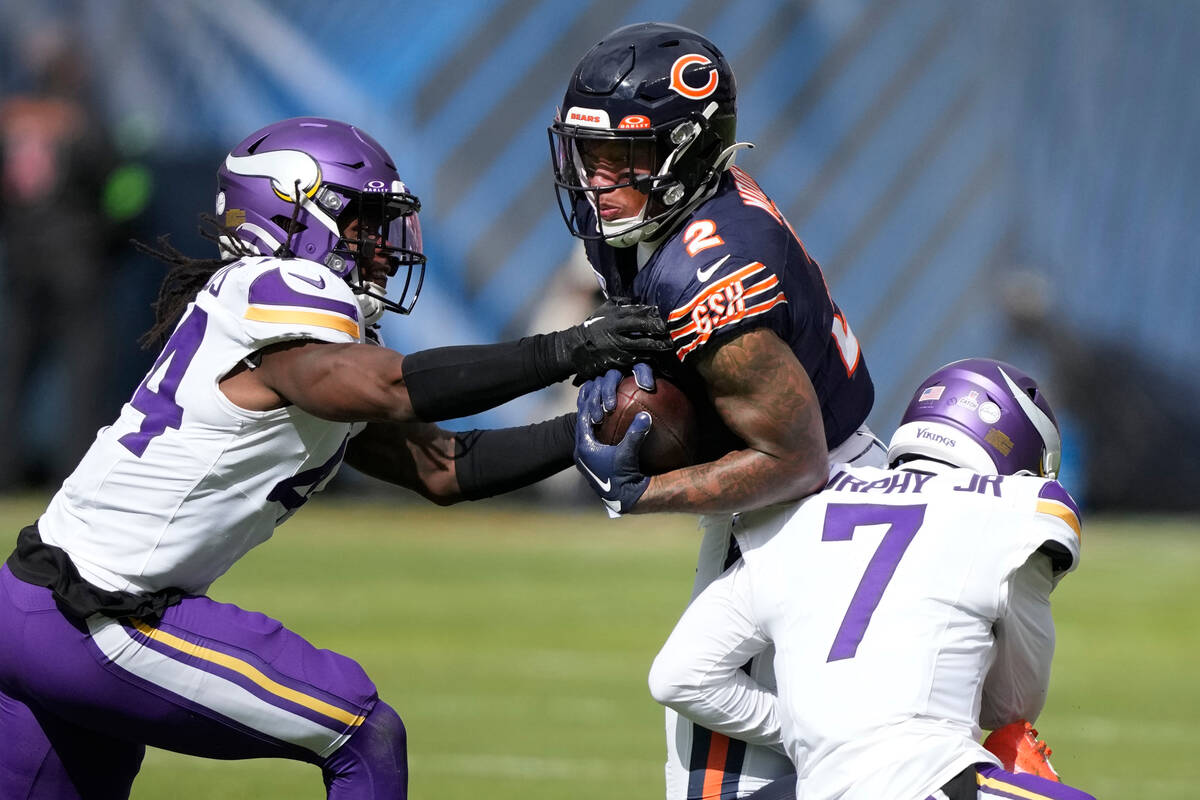Chicago Bears wide receiver DJ Moore (2) catches a pass from quarterback Justin Fields as Minne ...