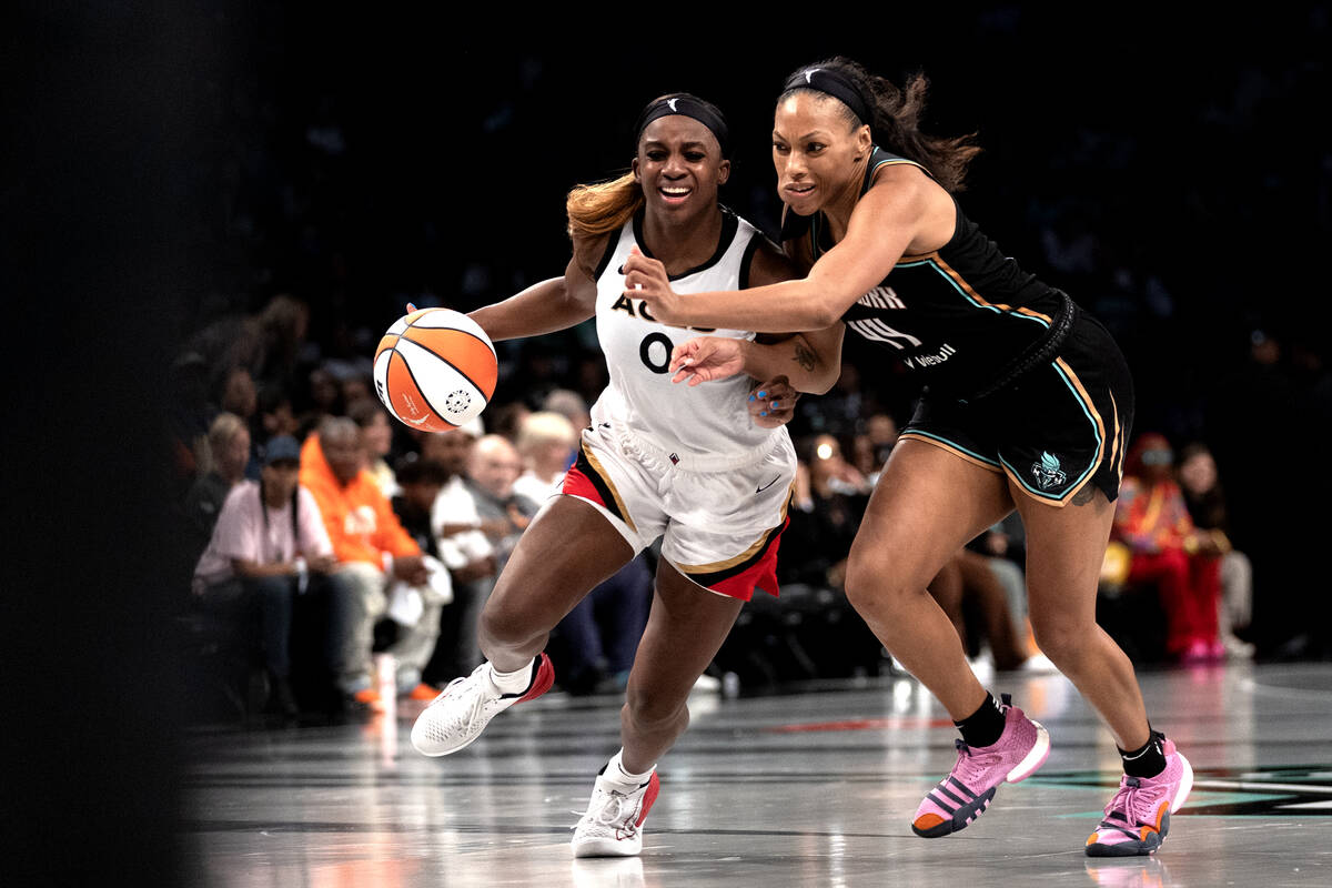 Las Vegas Aces guard Jackie Young (0) drives toward the hoop against New York Liberty forward B ...