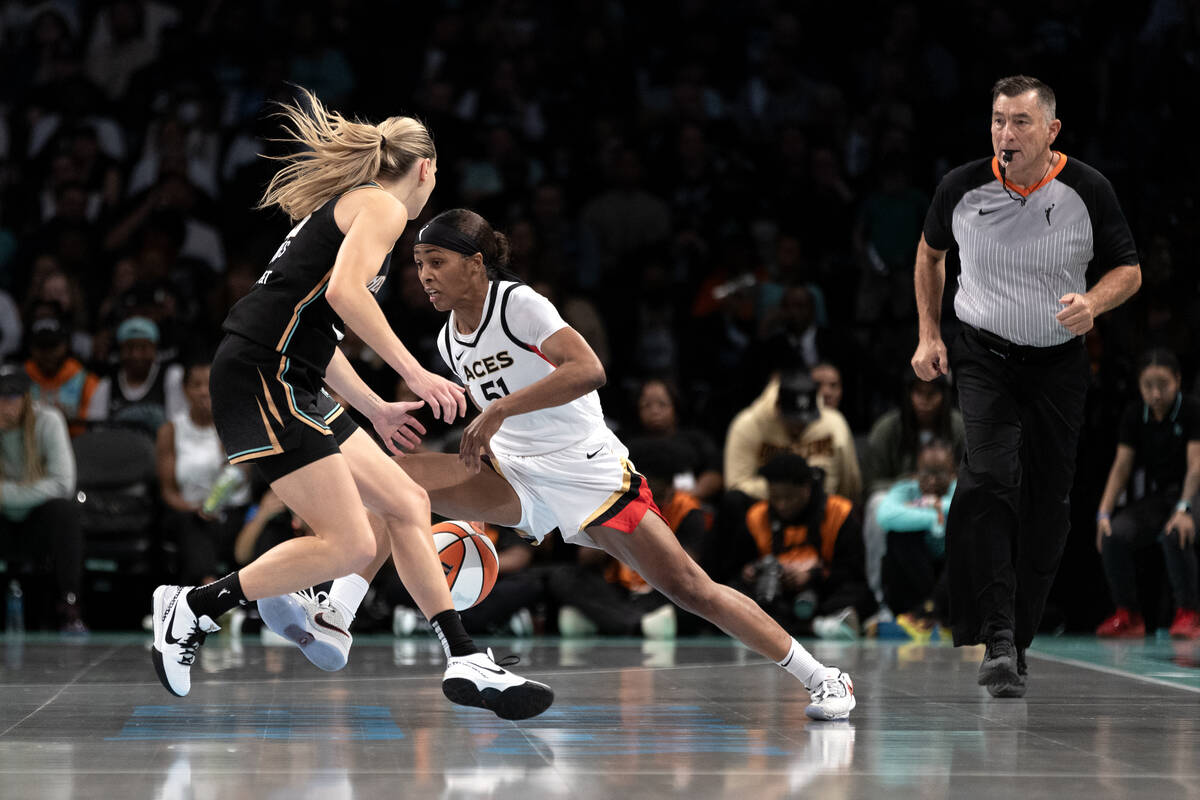 Las Vegas Aces guard Sydney Colson (51) dribbles around New York Liberty guard Marine Johannes ...