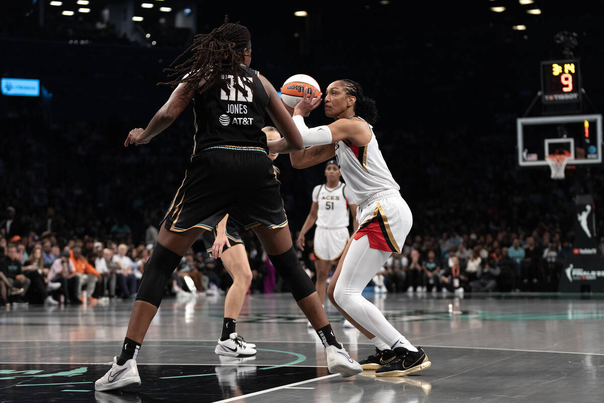 Las Vegas Aces forward A'ja Wilson (22) bends to shoot against New York Liberty forward Jonquel ...