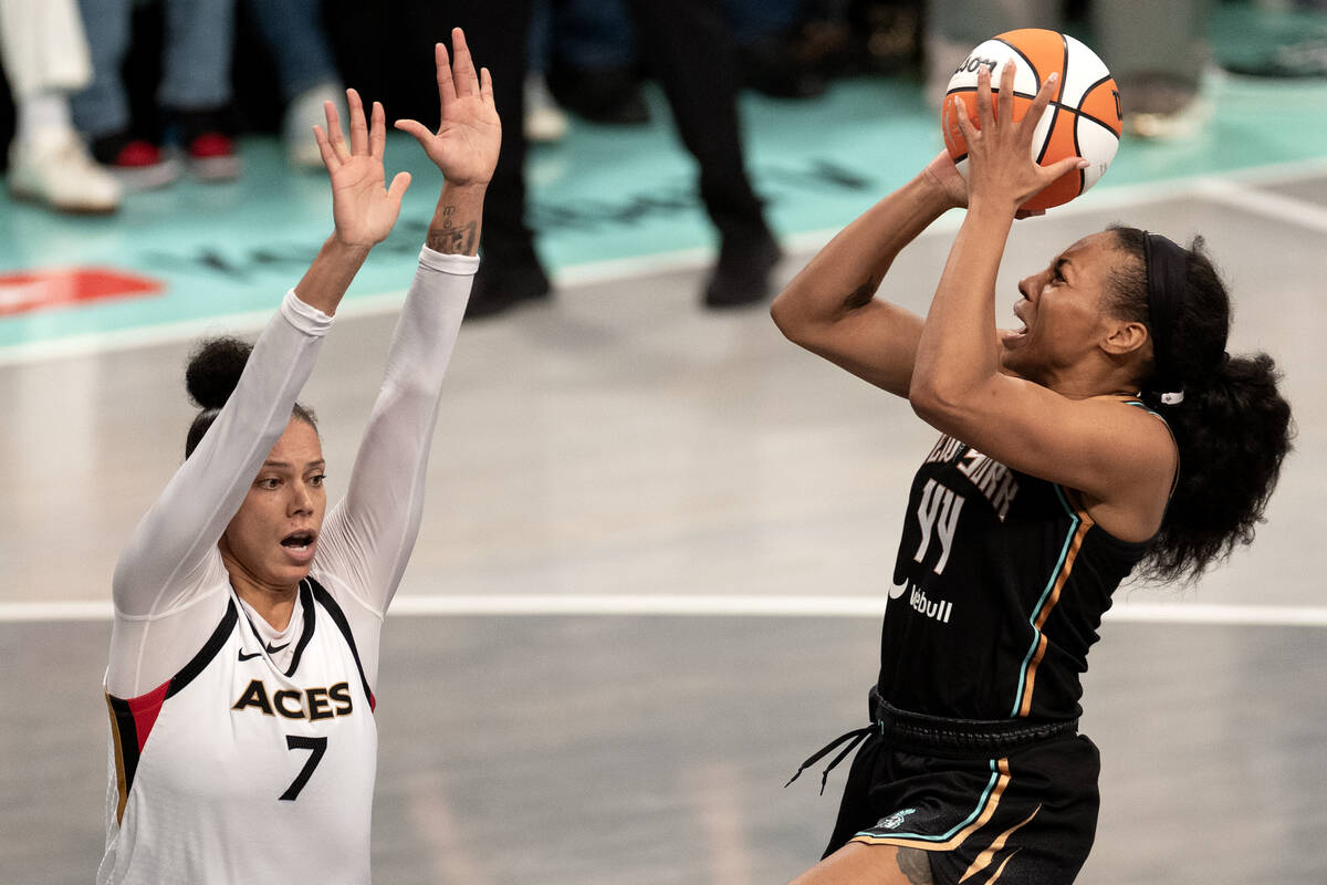 Las Vegas Aces forward Alysha Clark (7) attempts to block New York Liberty forward Betnijah Lan ...
