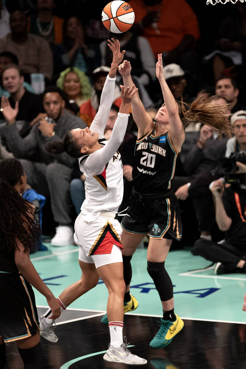 Las Vegas Aces forward Alysha Clark (7) battles at the hoop with New York Liberty guard Sabrina ...