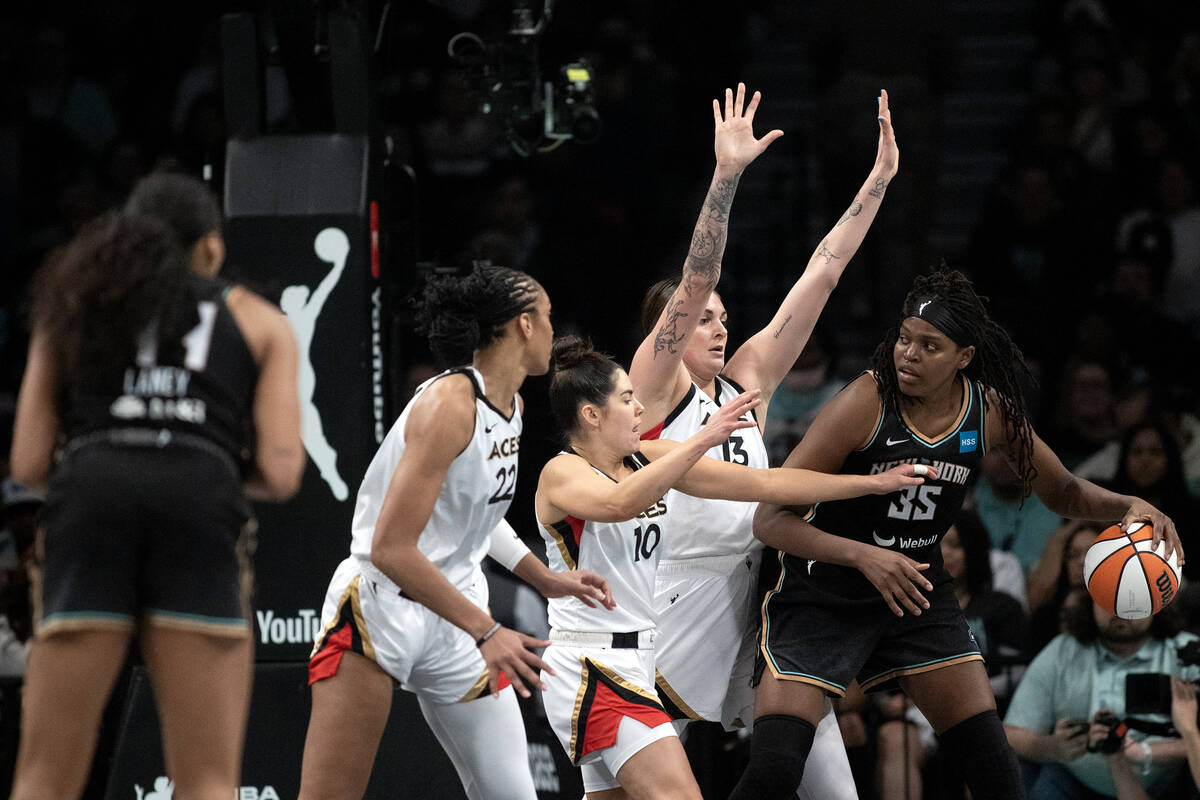 New York Liberty forward Jonquel Jones (35) is confronted by Las Vegas Aces forward A'ja Wilson ...