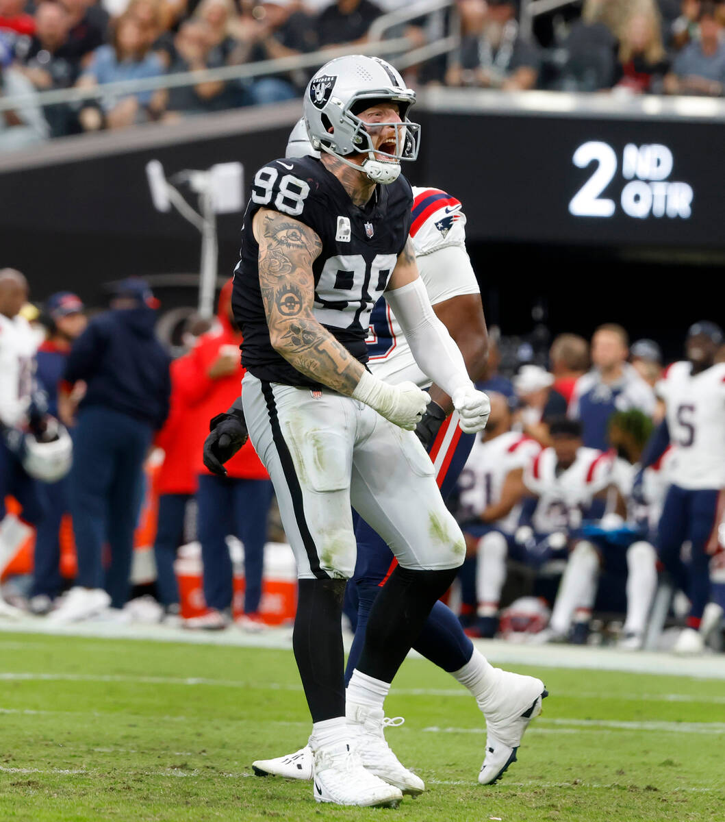 Raiders defensive end Maxx Crosby (98) reacts after sacking New England Patriots quarterback Ma ...