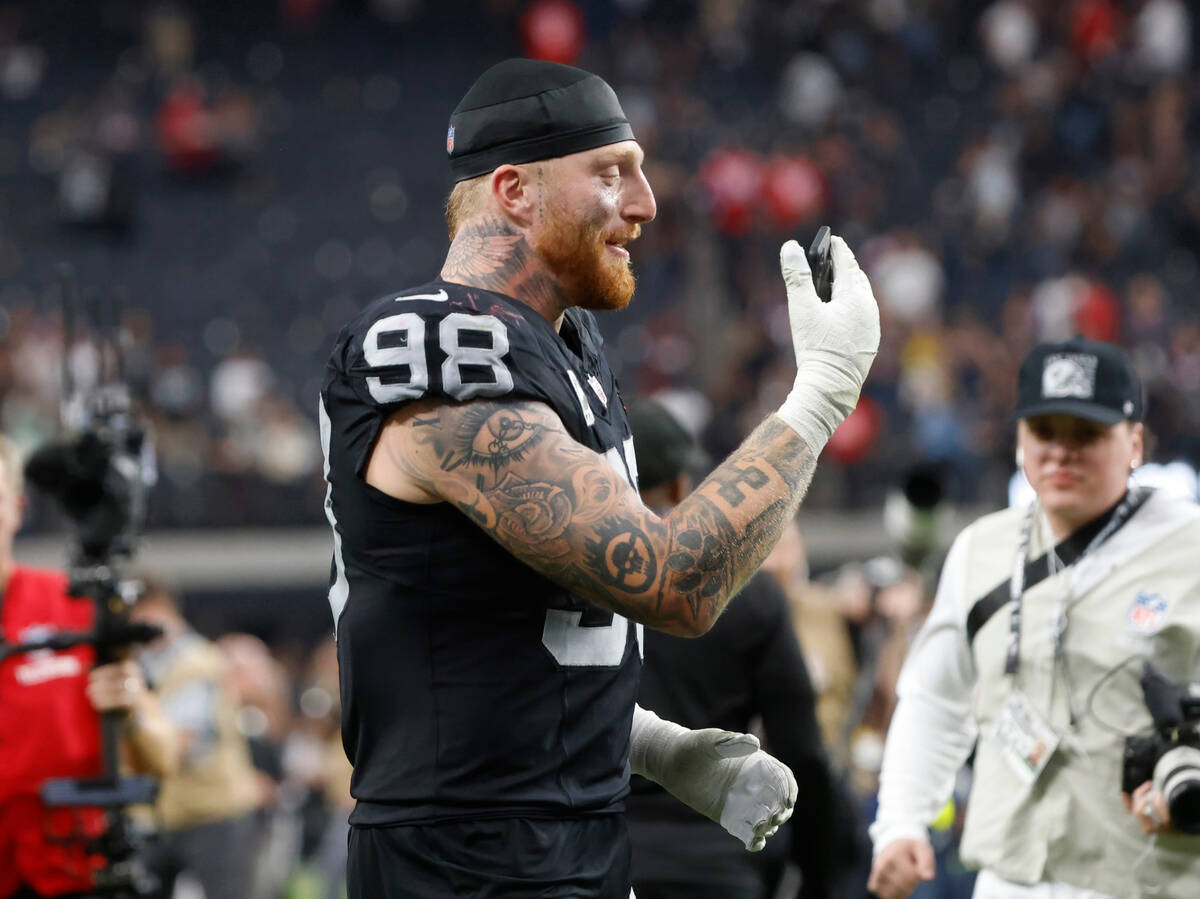 Raiders defensive end Maxx Crosby (98) facetimes as he leaves the field after defeating New En ...