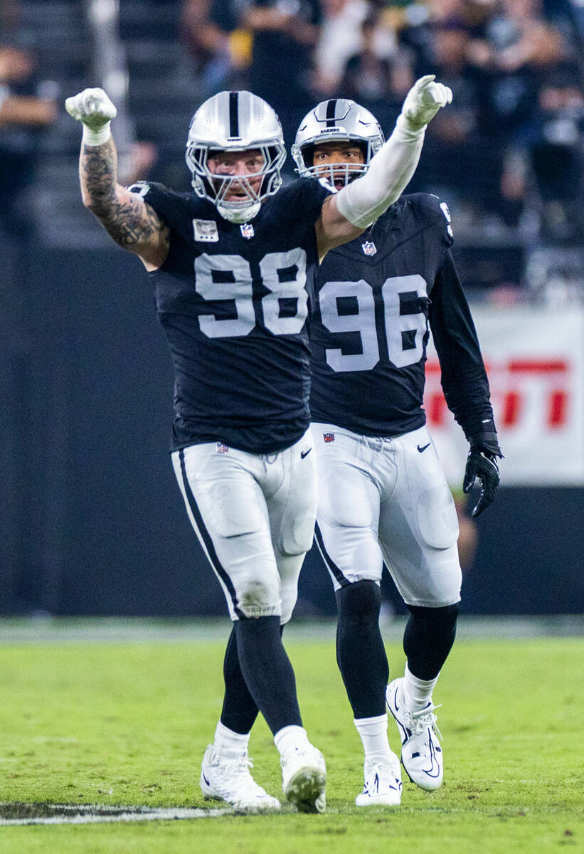 Raiders defensive end Maxx Crosby (98) celebrates another sack with defensive end Isaac Rochell ...