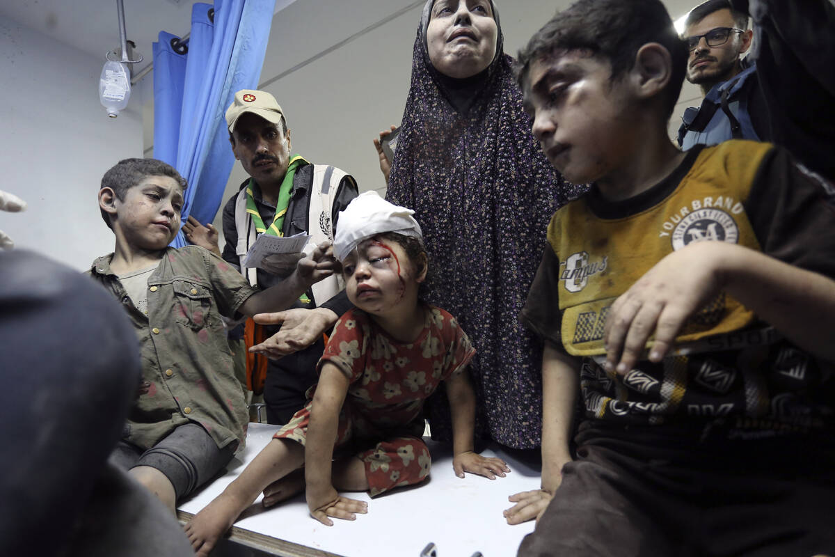Wounded Palestinians arrive at the al-Shifa hospital following Israeli airstrikes on Gaza City, ...