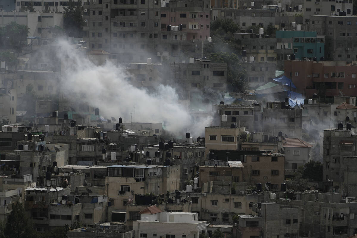 Smoke rises during an Israeli military raid on Nur Shams, West Bank, on Thursday, Oct. 19, 2023 ...