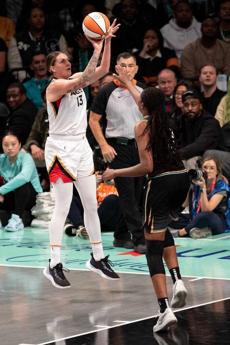 Las Vegas Aces forward Cayla George (13) shoots against New York Liberty forward Jonquel Jones ...