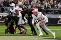 Ohio State quarterback Kyle McCord (6) runs past Purdue linebacker Kydran Jenkins (4) during th ...