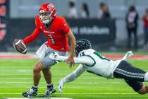 UNLV quarterback Jayden Maiava (1) evades a tackle by Hawaii defensive lineman Wynden Ho'ohuli ...