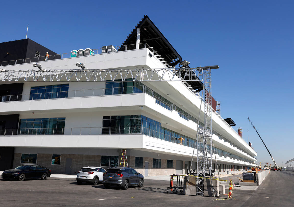 Workers are seen as they add the finishing touches to The F1 Pit Building during a media tour, ...