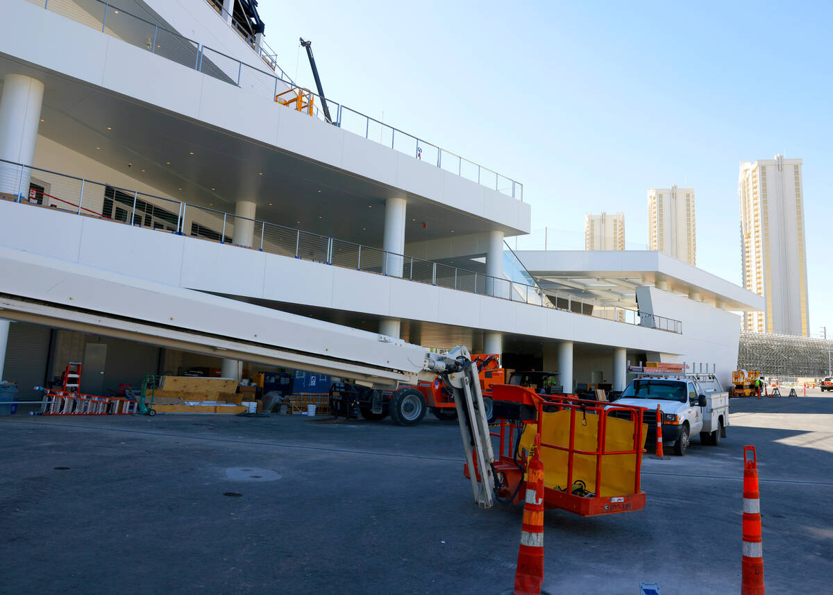 Workers are seen as they add the finishing touches to The F1 Pit Building during a media tour, ...