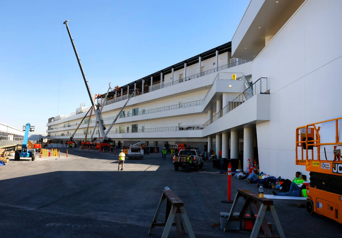 Workers are seen as they add the finishing touches to The F1 Pit Building during a media tour, ...