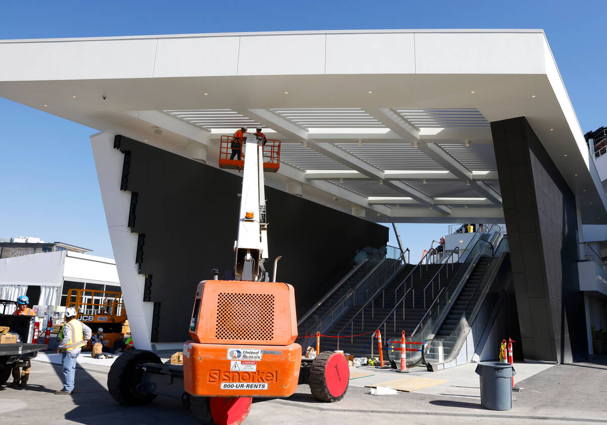 Workers are seen as they add the finishing touches to The F1 Pit Building during a media tour, ...