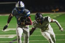 Basic wide receiver Zuri Whiters (23) runs the ball down the field as Foothill defensive end Te ...