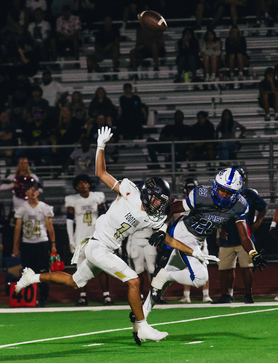Foothill wide receiver Travis Kenzevich (1) misses the ball as Basic safety Zuri Whiters (23) c ...