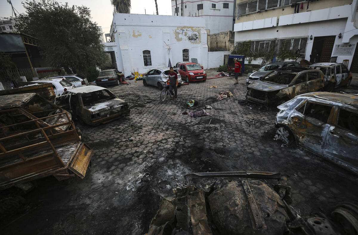 Palestinians check the area of the explosion at al-Ahli Hospital in Gaza City, Wednesday, Oct. ...