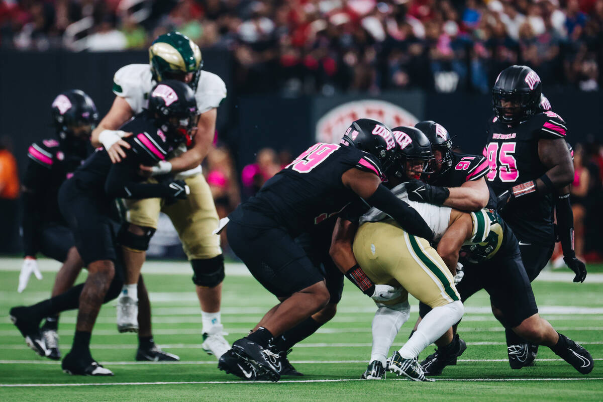 UNLV defenders try to hold off a Colorado State player during a game at Allegiant Stadium on Sa ...
