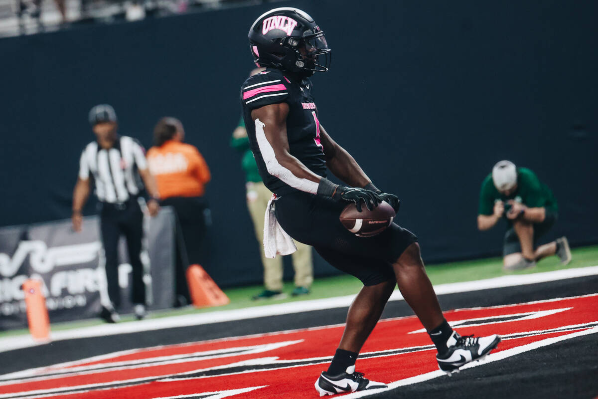 UNLV running back Donavyn Lester (4) runs the ball into the end zone for a touchdown during a g ...