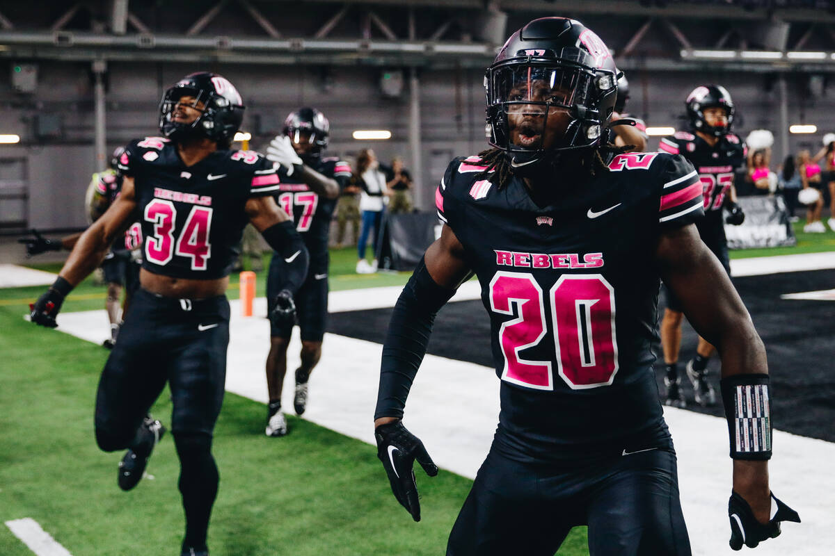 UNLV defensive back Trenton Holloway (20) and linebacker Tyray O'Dell (34) celebrate during a g ...