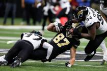 New Orleans Saints tight end Foster Moreau (87) is tackled by Jacksonville Jaguars cornerback T ...