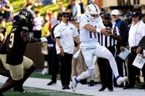 Pittsburgh quarterback Christian Veilleux (11) reaches for a first down as he runs past Wake Fo ...