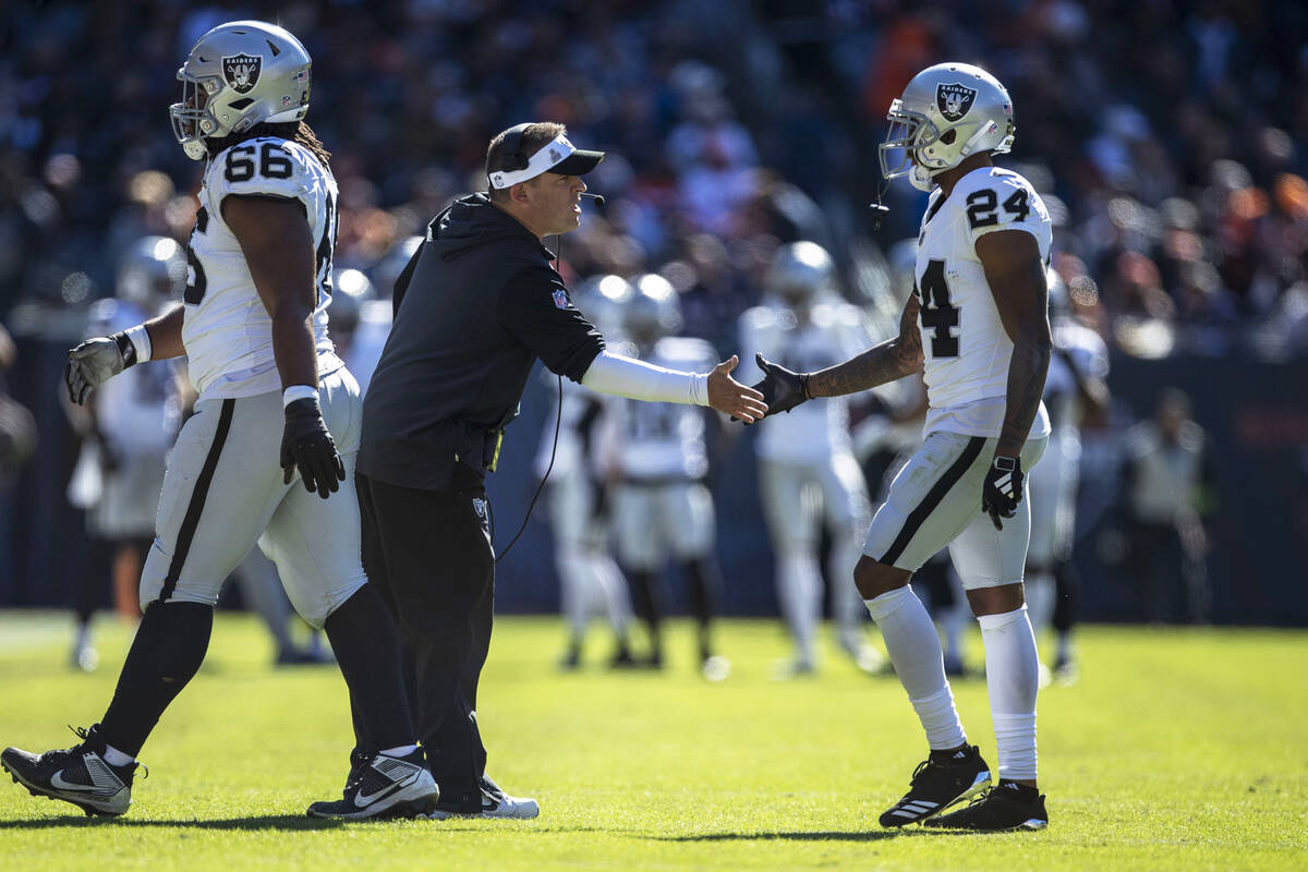 Raiders head coach Josh McDaniels congratulates Raiders cornerback Marcus Peters (24) after the ...