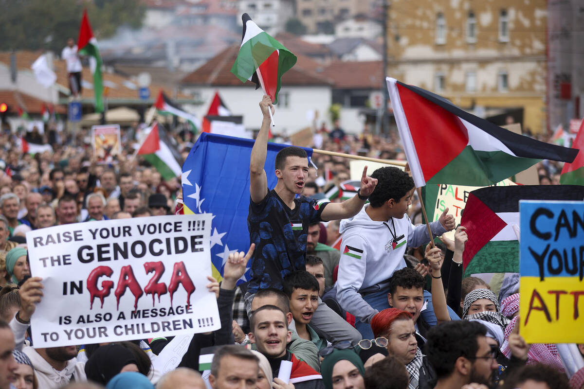 A Bosnian man waves a Palestinian flag and during a protest against Israel and in support of Pa ...