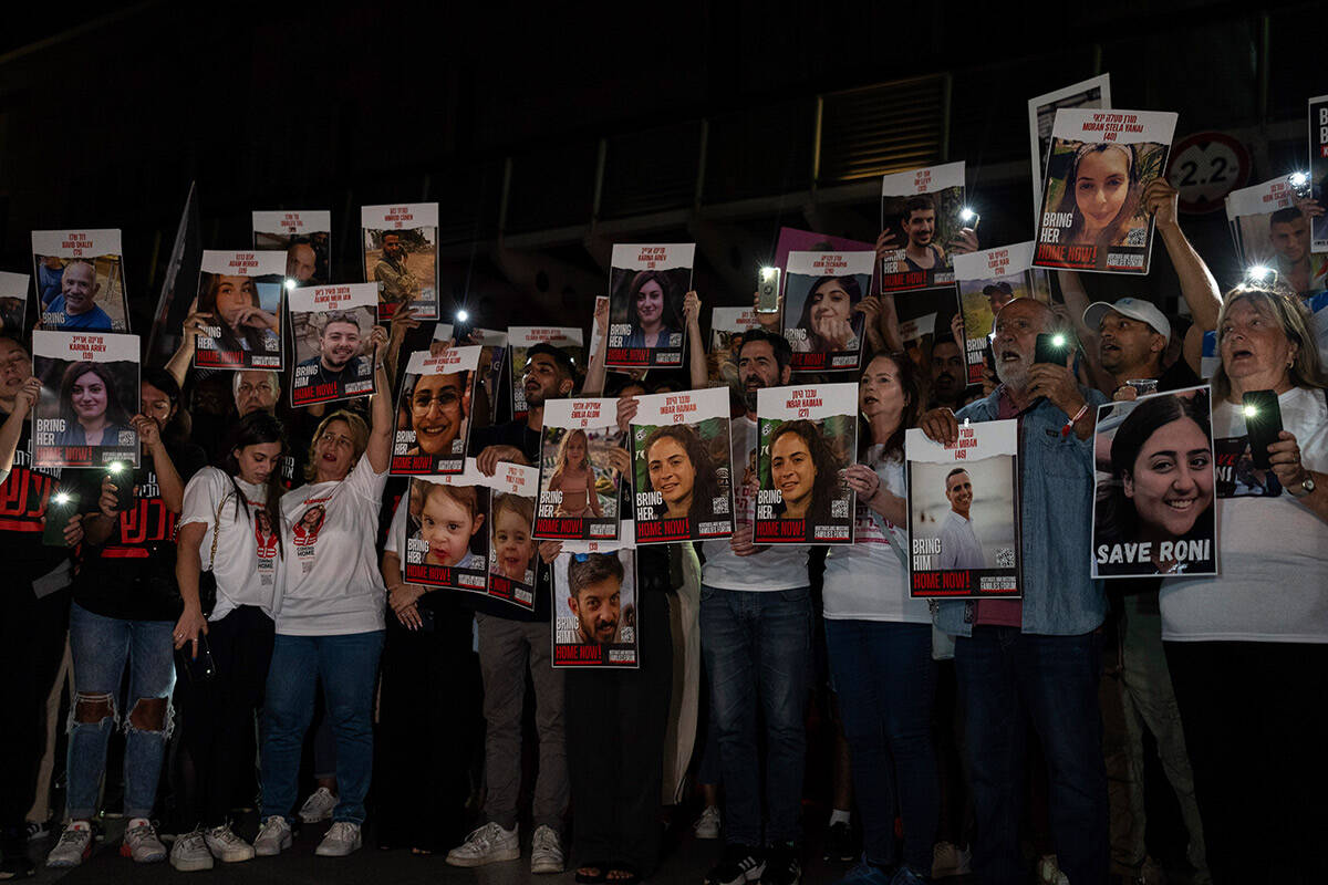 Relatives of people kidnapped by Hamas militants hold the pictures of their loved ones during a ...