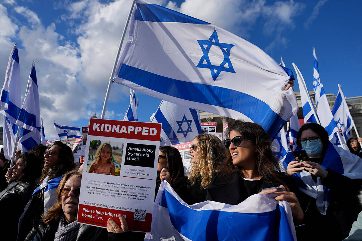 Israeli supports show placards with the faces and names of people believed to be taken hostage ...