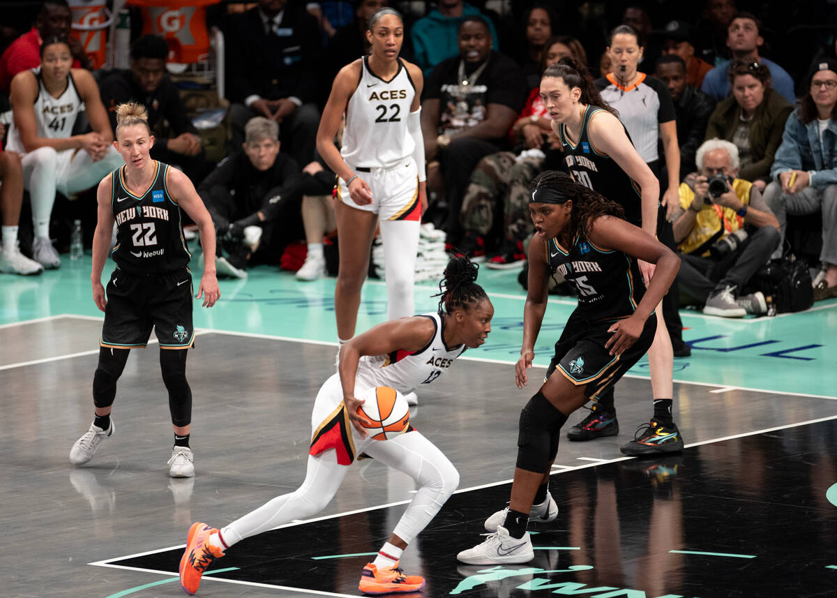 Las Vegas Aces guard Chelsea Gray (12) dribbles toward the hoop against New York Liberty forwar ...