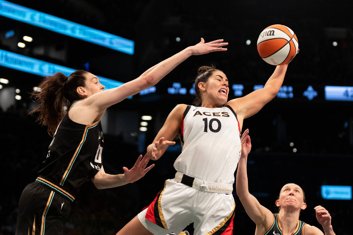 Las Vegas Aces guard Kelsey Plum (10) snags a rebound from New York Liberty forward Breanna Ste ...