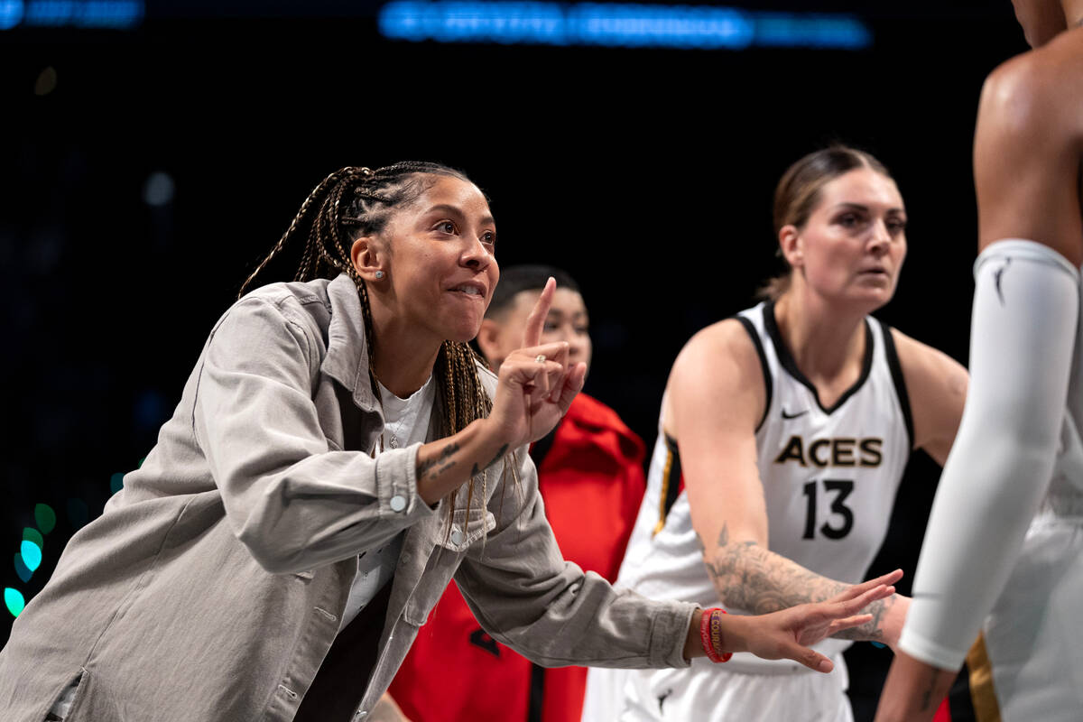 Las Vegas Aces forward Candace Parker gestures to forward A'ja Wilson, out of frame at right, i ...