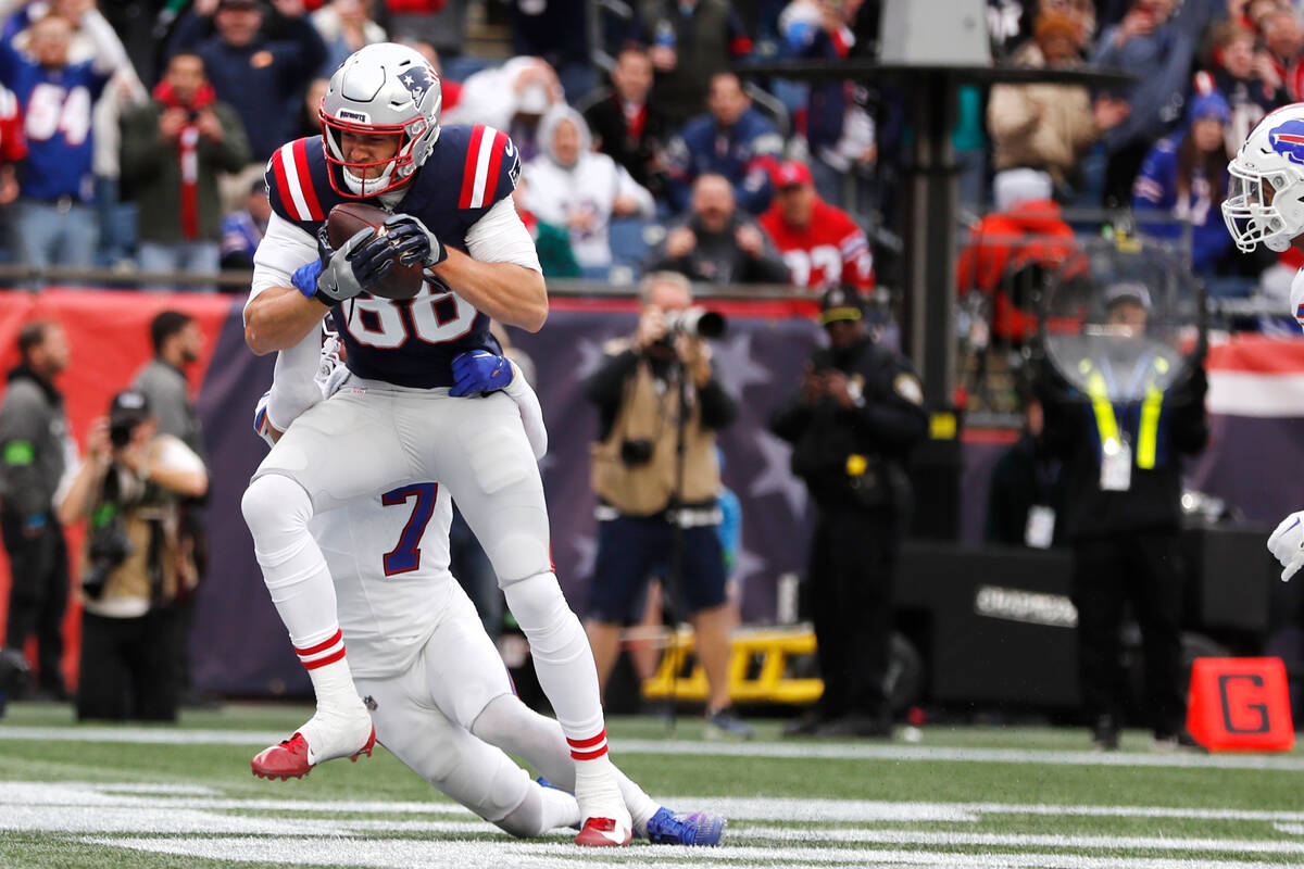 New England Patriots tight end Mike Gesicki (88) hangs onto the ball while beating Buffalo Bill ...