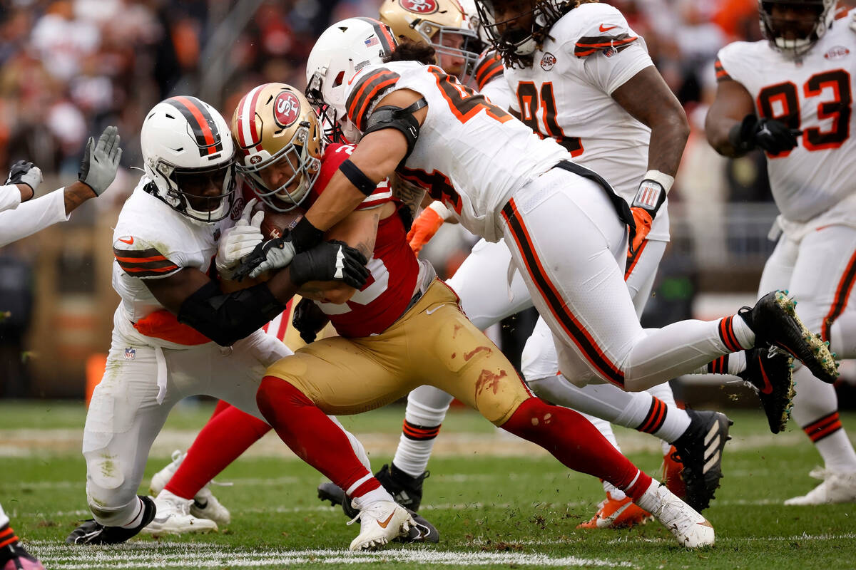 San Francisco 49ers running back Christian McCaffrey (23) is tackled by Cleveland Browns lineba ...