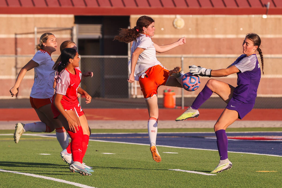 Bishop Gorman’s Hunter Borgel (24) takes a shot against Coronado’s Megan Kingman ...