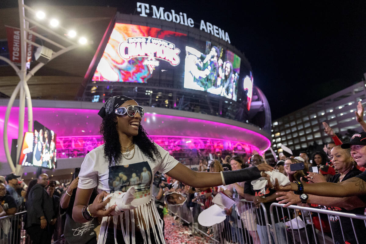 Las Vegas Aces forward A'ja Wilson (22) hands out t-shirts to fans during a celebration of the ...