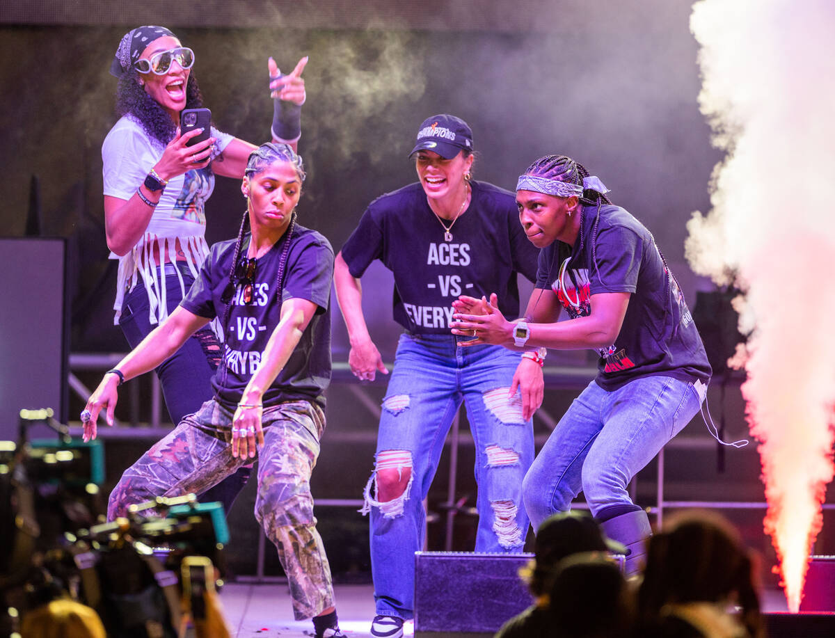 Aces players dance on stage as rapper 2 Chainz performs during their championship celebration ...