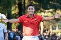 Collin Morikawa of the United States gestures to his wife, Katherine Zhu, not pictured, after w ...